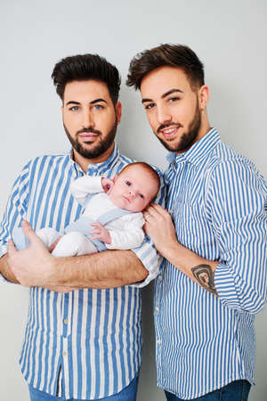 a gay couple with their son - gay parents conceptの写真素材