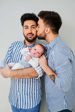 a gay couple with their son - gay parents conceptの写真素材