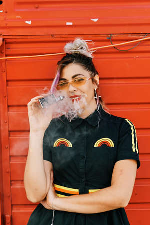 young girl with alternative look using vaporizer - lifestyle conceptの写真素材
