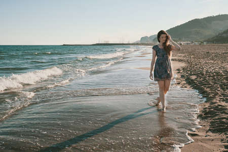 a model at the beach at sunsetの写真素材