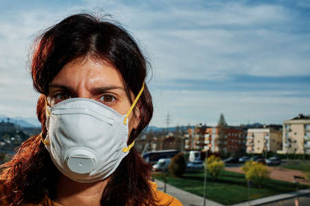 Young woman using mask to protect from virus - virus concept