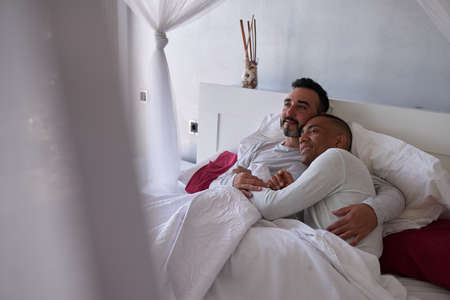 an interracial gay couple in bed