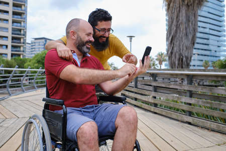 Carer Pushing Senior Man In Wheelchair - people with disabilites conceptの写真素材
