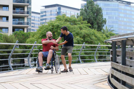 Carer Pushing Senior Man In Wheelchair - people with disabilites conceptの写真素材