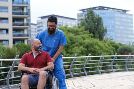 Carer Pushing Senior Man In Wheelchair - people with disabilites conceptの写真素材