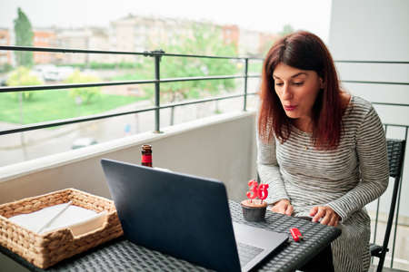 woman during coronavirus celebrates birthday with video conferenceの写真素材