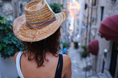 a young woman with hat in the streets of old town Dubrovnik, Croatiaの写真素材