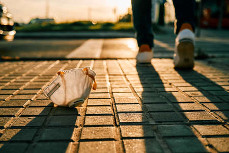 woman left behind a face mask and won virus battle - end of coronavirus conceptの写真素材