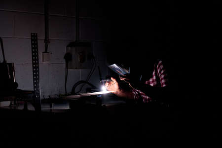 man welding in an industrial workshop