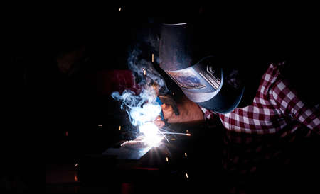 man welding in an industrial workshop
