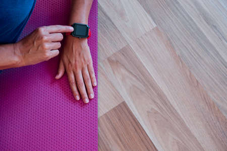 woman arm using smartwatch to control activity indoor