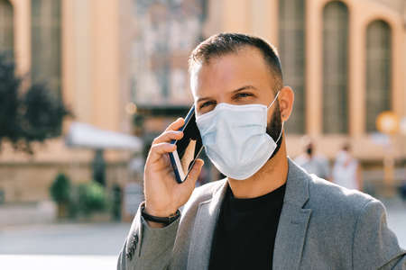 adult man in grey casual suit with mask and social distance - coronavirus concept