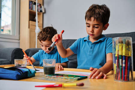 young boys playing with colors and drawingの写真素材