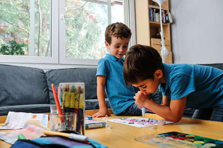 a young kid playing and painting with colorsの写真素材