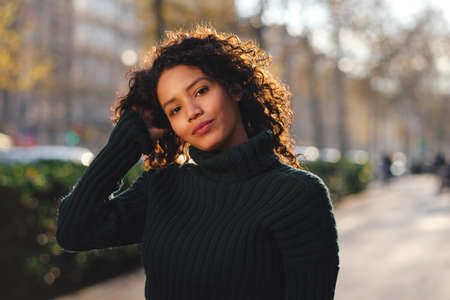 Young woman standing outdoors on the street.の写真素材