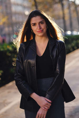 Woman standing outdoors on the street.