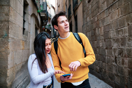 Couple using a mobile phone while enjoying a walk together.