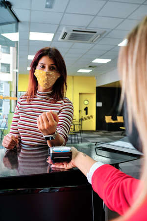 a woman pay using smartwatch using contactless technology - new normal