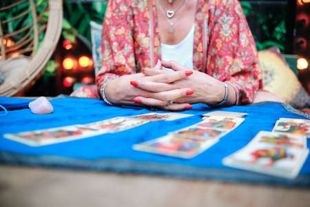close up of womans hand with tarot cards to predict future - esoteric conceptの写真素材