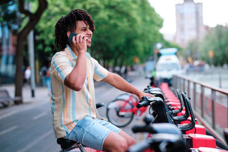 a young latin man ready to use a rented byecicle