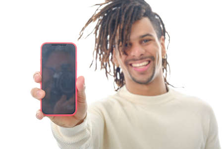Smiling man showing a mobile phone with blank screen to the camera while standing over an isolated background.の写真素材