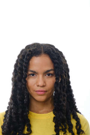 Close up view of a latin woman looking at camera with a serious expression on her face.の写真素材