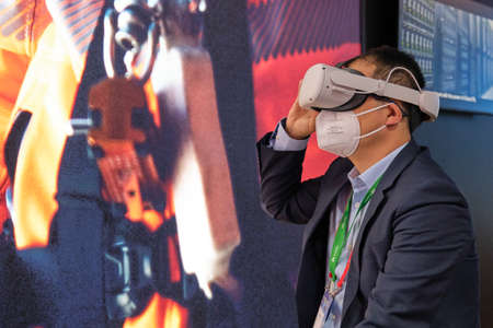 Barcelona, Spain - March 2nd 2022 - Mobile World Congress - A man testing virtual reality gadgetのeditorial素材