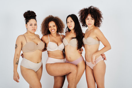 Happy diverse women in underwear in studioの写真素材