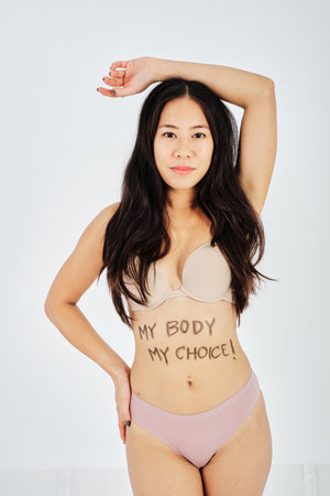 Undressed woman with My Body My Choice written on bellyの写真素材