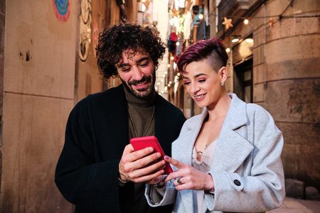 Friends using the mobile in the street
