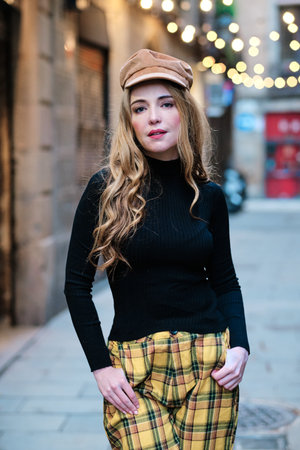 Blonde woman posing while looking at camera in the street