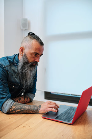 Man using a laptop while working in the office.