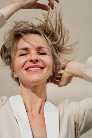 Close up view of a woman looking at camera and smiling.