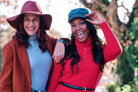 Beauty multiethnic women posing and smiling in a parkの写真素材