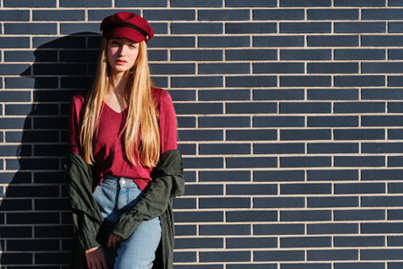 Sensual blonde model posing leaning on an urban wallの写真素材