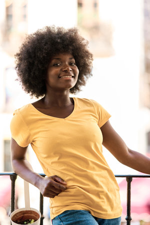 African woman smiling at the camera standing outdoorsの写真素材