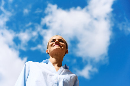 Businesswoman looking away outdoors in a sunny dayの写真素材