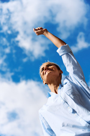 A happy businesswoman pointing to the skyの写真素材