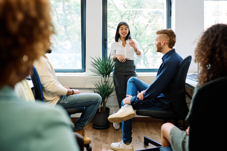 Chinese woman talking during a relaxed meeting on a coworkingの写真素材