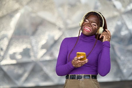 Vibrant Joyful Woman with Smartphone and Headphonesの写真素材