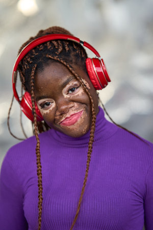 Serene Woman in Purple with Red Headphonesの写真素材