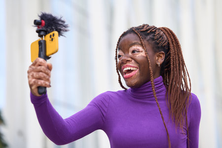 Joyful African American Woman Vlogging Outdoorsの写真素材