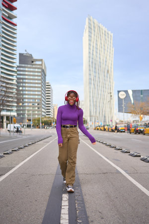 Joyful Woman Walking in Urban Settingの写真素材