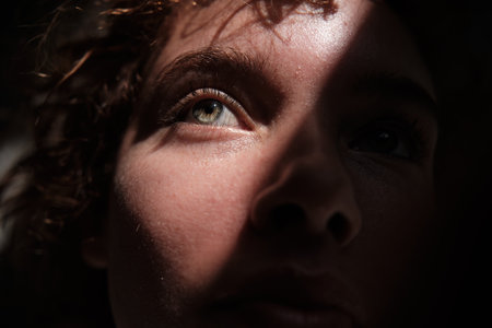 Person looking up with hope in eyeの写真素材