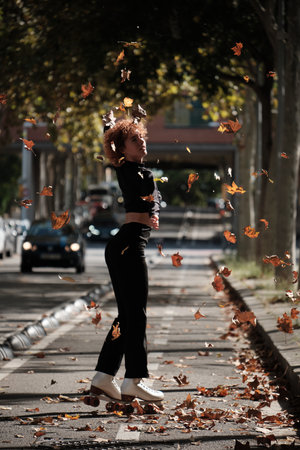 Woman roller skating on street during autumn seasonの写真素材