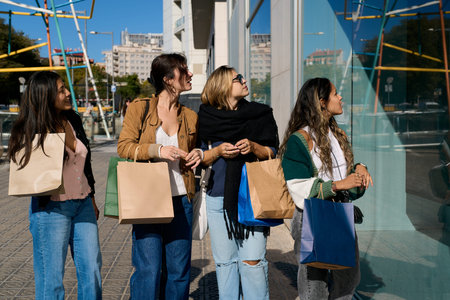 Group of women shopping together looking at shop window