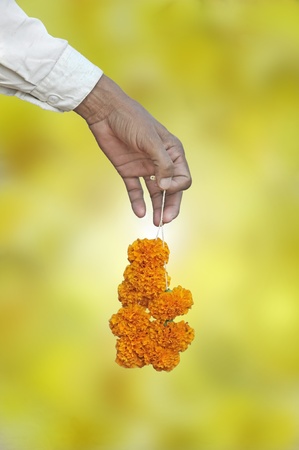 Seller with flowers in his hand in Varanasi, India.の写真素材