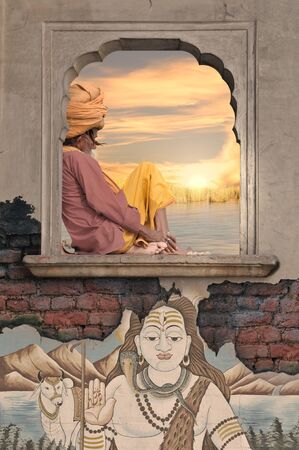 Holy man meditating on the window near Ganges.の写真素材