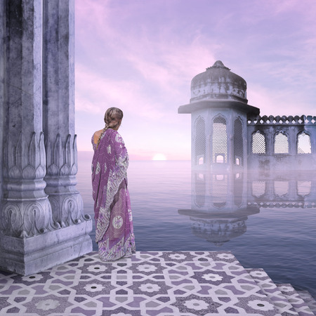 Indian woman in the mist during the sunrise.の写真素材