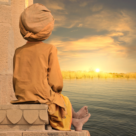 Hindu man meditating in a indian oasis.の写真素材